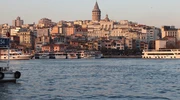 o barcă mică într-un corp de apă cu un oraș în fundal în turcia