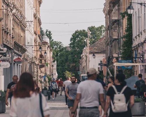 un grup de oameni care se plimbă pe o stradă a orașului în timișoara