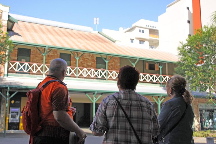 Walk Darwin guide and guests take a moment to enjoy the architecture of The Victoria Hotel.